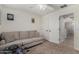 Bright bedroom featuring a ceiling fan, foosball table, a comfortable couch, and ample space at 27420 N 63Rd Dr, Phoenix, AZ 85083