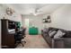 Comfortable bedroom features a cozy sofa, desk area, and abundant natural light at 27420 N 63Rd Dr, Phoenix, AZ 85083