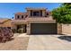 Inviting two-story home featuring a well-maintained front yard with a spacious two car garage at 27420 N 63Rd Dr, Phoenix, AZ 85083
