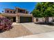 Inviting two-story home featuring a well-maintained front yard with a spacious driveway at 27420 N 63Rd Dr, Phoenix, AZ 85083