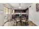 Eat-in kitchen with a glass top table, dark wood cabinets and stainless steel appliances at 27420 N 63Rd Dr, Phoenix, AZ 85083