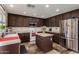 Spacious kitchen with dark cabinets, a center island, stainless steel appliances, and tile flooring at 27420 N 63Rd Dr, Phoenix, AZ 85083