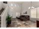 Bright living room with soaring ceilings, tiled floor and a comfortable brown sectional couch at 27420 N 63Rd Dr, Phoenix, AZ 85083