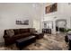 Bright living room with soaring ceilings, tiled floors, and an open floor plan at 27420 N 63Rd Dr, Phoenix, AZ 85083