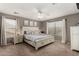 Comfortable main bedroom featuring neutral walls, a ceiling fan, a large window, and carpeted floors at 27420 N 63Rd Dr, Phoenix, AZ 85083