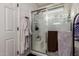 Bright and clean tiled shower with a glass door, rainfall shower head, and a built-in bench at 27420 N 63Rd Dr, Phoenix, AZ 85083