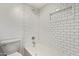 Bathroom with subway tile shower, matching fixtures, and a white toilet at 2834 S Extension Rd # 2005, Mesa, AZ 85210