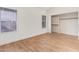Bright bedroom with wood-look floors, white walls, base molding, and two windows at 2834 S Extension Rd # 2005, Mesa, AZ 85210