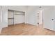 Spacious bedroom with wood-look floors, walk-in closet, and white walls at 2834 S Extension Rd # 2005, Mesa, AZ 85210