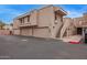 Condominium exterior featuring a private garage, an exterior staircase, and a desert-toned facade at 2834 S Extension Rd # 2005, Mesa, AZ 85210