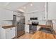 White kitchen features stainless steel appliances, wood countertops, and ample cabinet space at 2834 S Extension Rd # 2005, Mesa, AZ 85210