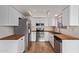 Updated kitchen with white cabinets, stainless steel appliances, and butcher block countertops at 2834 S Extension Rd # 2005, Mesa, AZ 85210