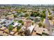 An aerial view shows single-Gathering homes with green trees and landscaping in a quiet residential neighborhood at 3115 N 26Th St, Phoenix, AZ 85016