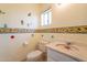 Whimsical bathroom featuring sunflower accents, toilet, vanity, and a window for natural light at 3115 N 26Th St, Phoenix, AZ 85016