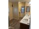 Bathroom featuring double sinks, tile flooring, and an adjacent shower area, providing functionality and style at 3115 N 26Th St, Phoenix, AZ 85016