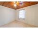 Bedroom features a ceiling fan, wood ceiling, and a window at 3115 N 26Th St, Phoenix, AZ 85016