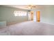 Bright, spacious bedroom with soft carpeting, ceiling fan, and two closets for storage at 3115 N 26Th St, Phoenix, AZ 85016