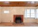 Living room fireplace featuring wood-look floors and a unique wood panel ceiling at 3115 N 26Th St, Phoenix, AZ 85016