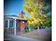 Charming front yard with a well-manicured lawn, mature tree, and inviting porch area at 3115 N 26Th St, Phoenix, AZ 85016