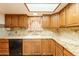 Kitchen features wooden cabinets, granite countertops, and stainless-steel appliances at 3115 N 26Th St, Phoenix, AZ 85016