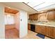 Kitchen area with wooden cabinets, tile countertops, and view to dining area at 3115 N 26Th St, Phoenix, AZ 85016