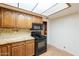 Kitchen features wooden cabinets, granite countertops, and modern black appliances at 3115 N 26Th St, Phoenix, AZ 85016