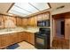 Kitchen features wooden cabinets, granite countertops, and black appliances at 3115 N 26Th St, Phoenix, AZ 85016