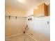 Functional laundry room with upper cabinets, shelving, and utility connections for convenience at 3115 N 26Th St, Phoenix, AZ 85016