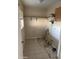 Depicts the laundry room featuring tile flooring, shelving, and connection to the water source at 3115 N 26Th St, Phoenix, AZ 85016