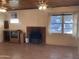 Living area with a brick fireplace and ceiling fan, ready for updates and comfortable living at 3115 N 26Th St, Phoenix, AZ 85016