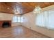 Bright living room with wood ceiling, brick fireplace, and lots of windows at 3115 N 26Th St, Phoenix, AZ 85016
