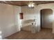 Inviting living area with arched entry, lamp and unique ceiling, awaiting personal touches for cozy living at 3115 N 26Th St, Phoenix, AZ 85016