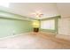 Spacious living room features neutral carpet, soft green walls, and natural light from a large window at 3115 N 26Th St, Phoenix, AZ 85016