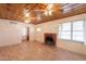 Spacious living room featuring a fireplace, wood-look floors, and a unique wood panel ceiling at 3115 N 26Th St, Phoenix, AZ 85016