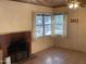 Living room with a brick fireplace and windows offering a cozy space ready to be personalized at 3115 N 26Th St, Phoenix, AZ 85016