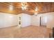 Open living room featuring wood-look floors and a unique wood panel ceiling at 3115 N 26Th St, Phoenix, AZ 85016