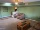 Spacious living room featuring large windows, natural light, comfortable seating, and a ceiling fan at 3115 N 26Th St, Phoenix, AZ 85016