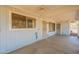 Enclosed patio with concrete floor, blue wood panelling, and entry doors at 3115 N 26Th St, Phoenix, AZ 85016