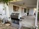 Covered patio with a grill, outdoor seating, and access to the home at 3115 N 26Th St, Phoenix, AZ 85016