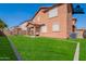 Spacious backyard with a covered patio and lush green lawn at 316 N 78Th Pl, Mesa, AZ 85207