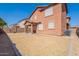 A spacious backyard with a covered patio, grass, and block wall fencing for privacy at 316 N 78Th Pl, Mesa, AZ 85207