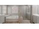 Bright bathroom featuring a soaking tub and a glass-enclosed shower at 316 N 78Th Pl, Mesa, AZ 85207