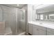Bathroom highlighting a glass-enclosed shower, tiled walls, and vanity with sink at 316 N 78Th Pl, Mesa, AZ 85207