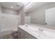Well-lit bathroom featuring double sinks, a large mirror, and bathtub-shower combo at 316 N 78Th Pl, Mesa, AZ 85207