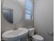 Cozy half bathroom featuring a pedestal sink and modern fixtures at 316 N 78Th Pl, Mesa, AZ 85207
