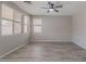 Bright bedroom featuring wood-look tile flooring, neutral walls, and ample natural light at 316 N 78Th Pl, Mesa, AZ 85207