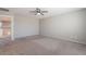 Carpeted bedroom with neutral walls, ceiling fan, and a glimpse into the home's second level at 316 N 78Th Pl, Mesa, AZ 85207