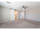 Bedroom featuring a ceiling fan, neutral walls, plush carpeting, and doorway to the ensuite bathroom at 316 N 78Th Pl, Mesa, AZ 85207