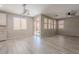 Open dining area with wood-look tile floor and modern light fixture near a sliding glass door at 316 N 78Th Pl, Mesa, AZ 85207