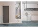 Garage interior featuring a water heater, water softener, door, and overhead storage racks at 316 N 78Th Pl, Mesa, AZ 85207